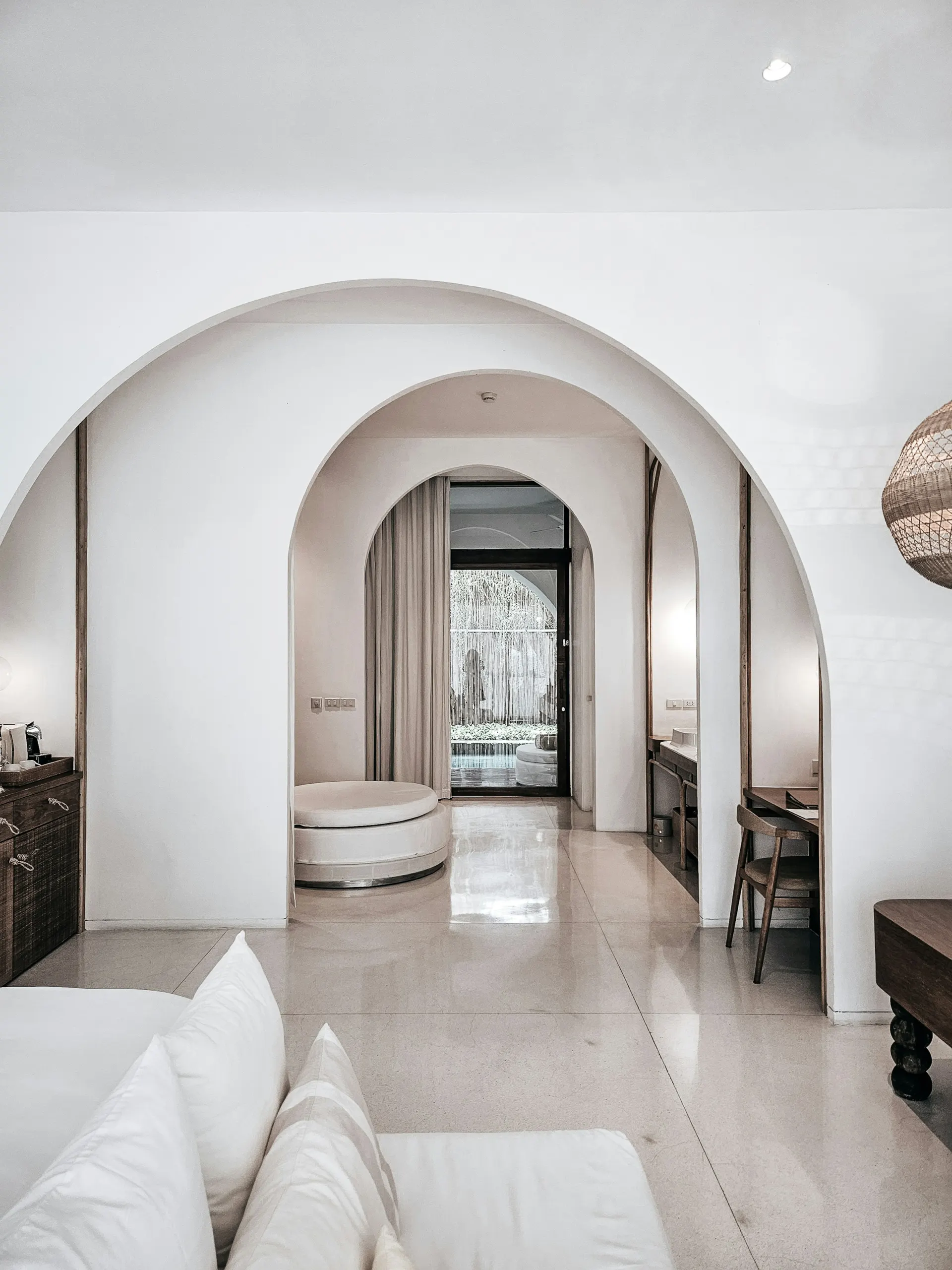 Arched interior of a minimal whitewashed suite