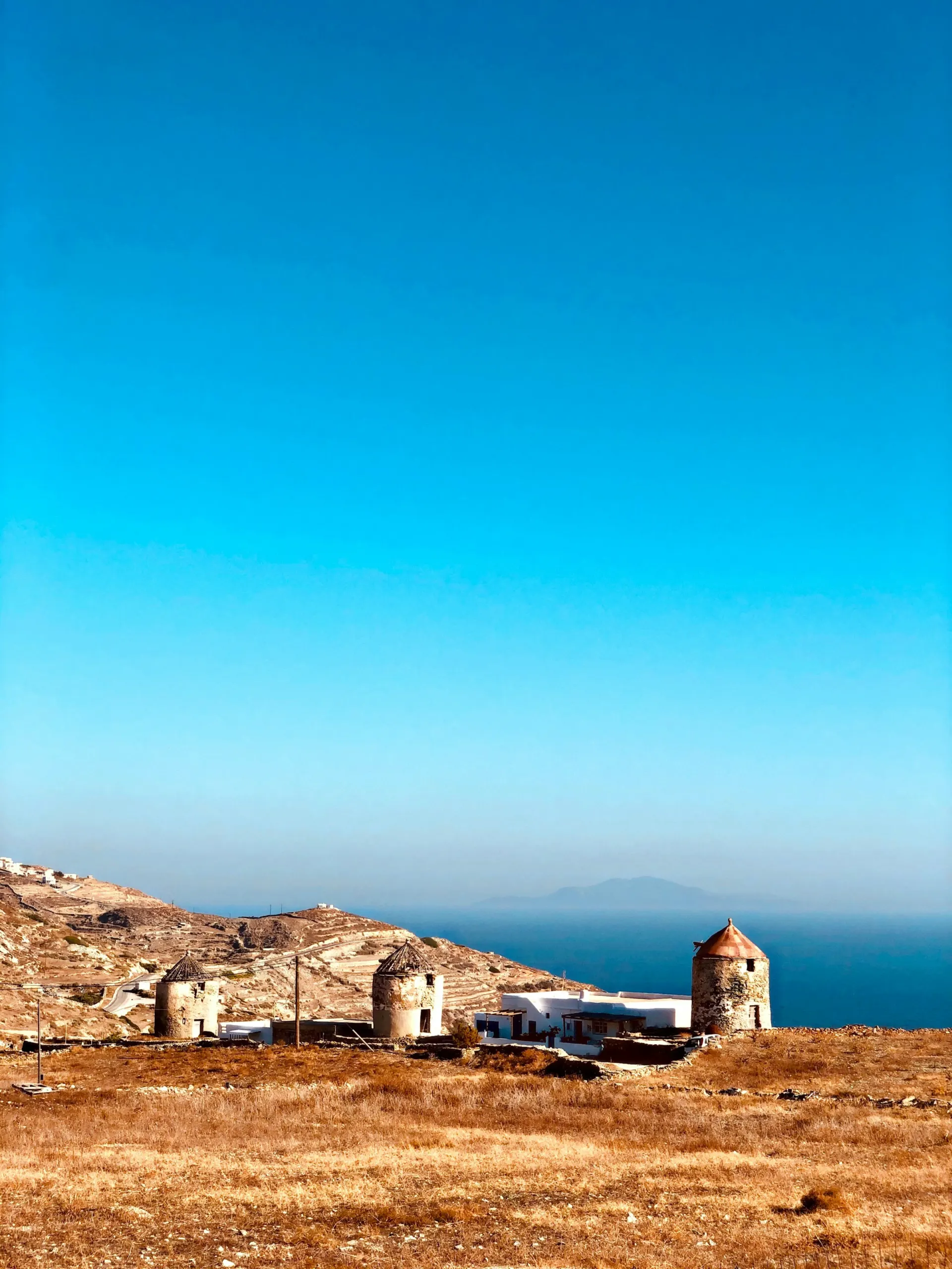 Cycladic village beneath a rocky ridge